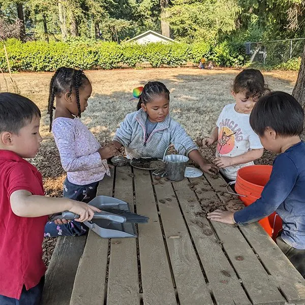A chld gardening with a Montessori guide