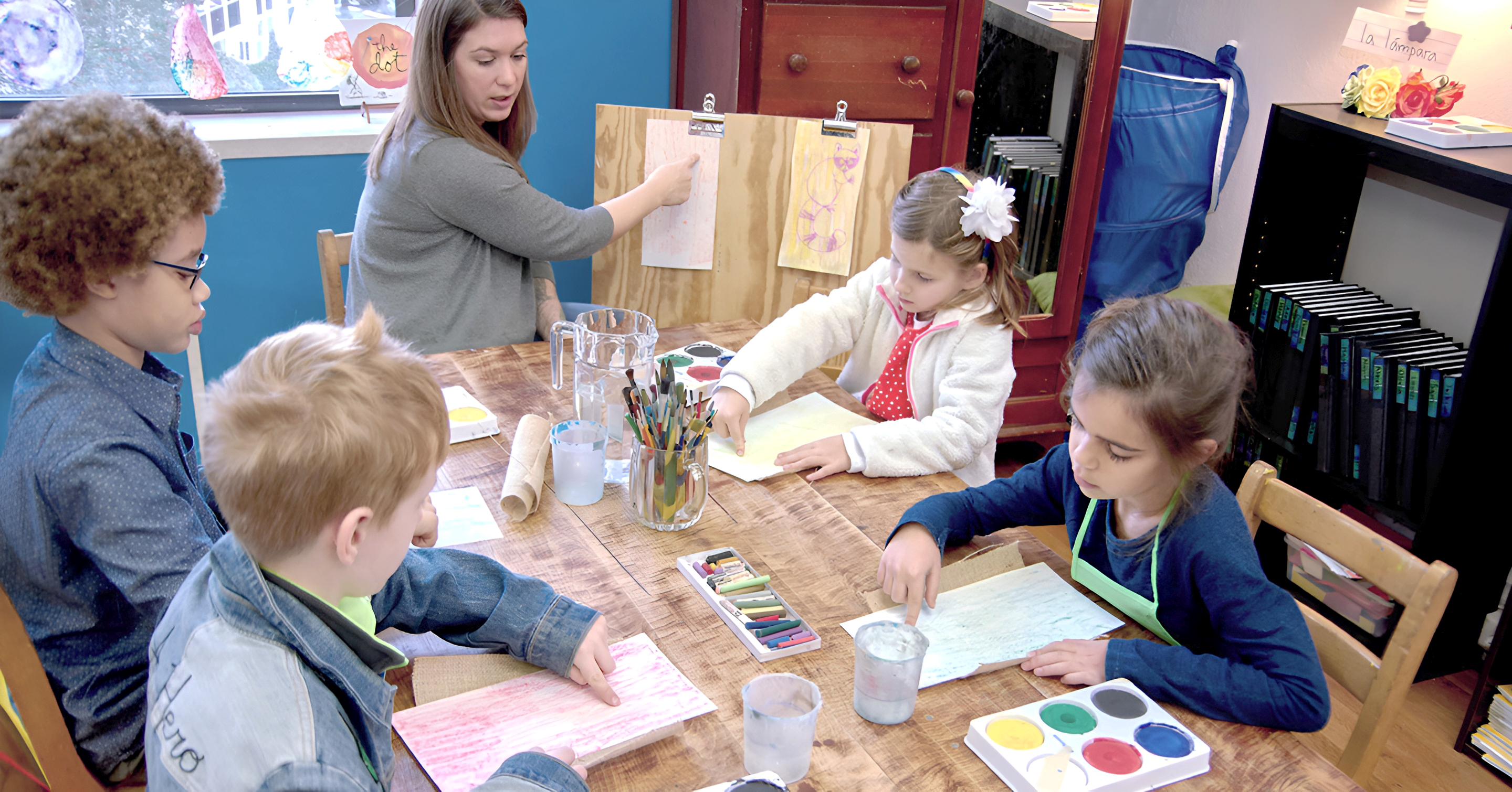 Art class. CMS students painting with Montessori guide