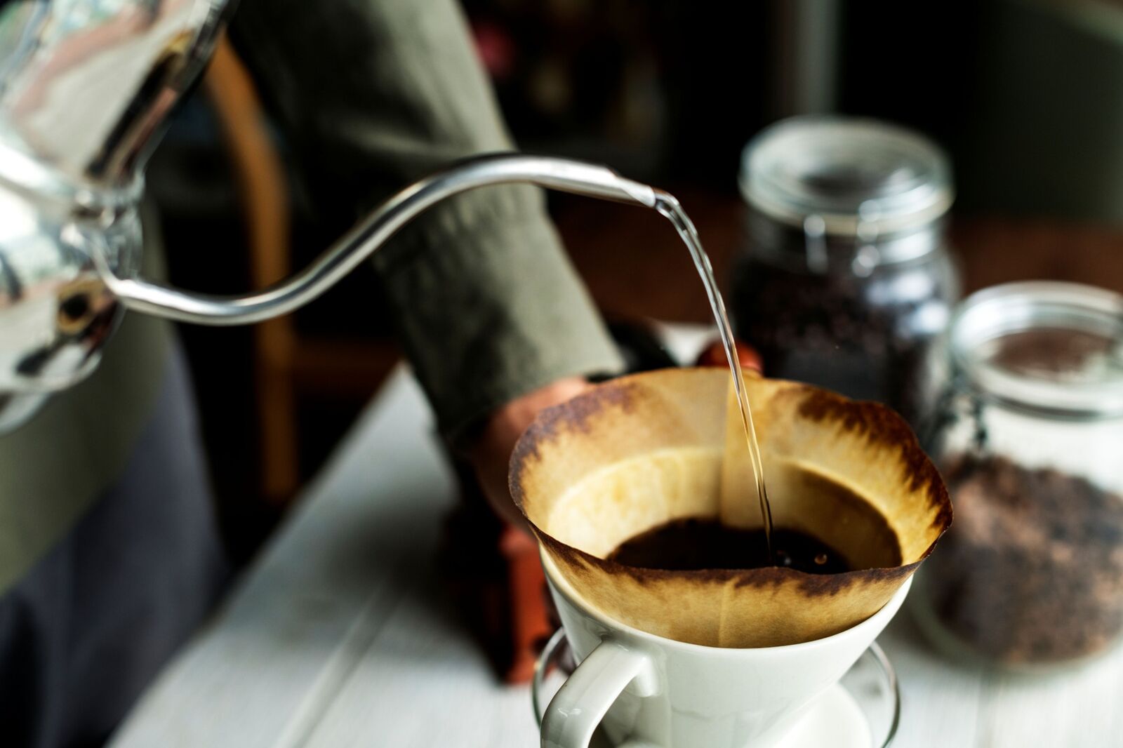 Hot water being poured over coffee grounds in a pour-over dripper