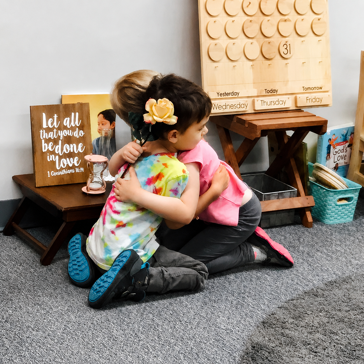 Two children hugging in a classroom